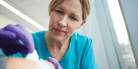 Health care provider checking a pressure injury