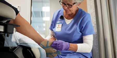 health care provider looking at a diabetic foot ulcer